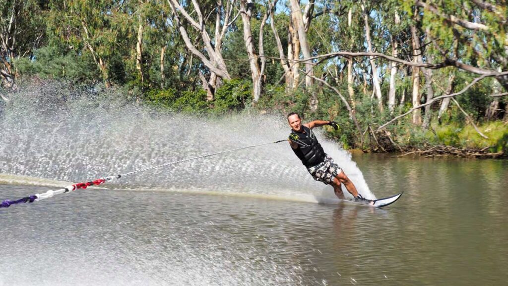 What Does a Slashing Hand Motion Over the Neck Mean by a Waterskiing Participant?