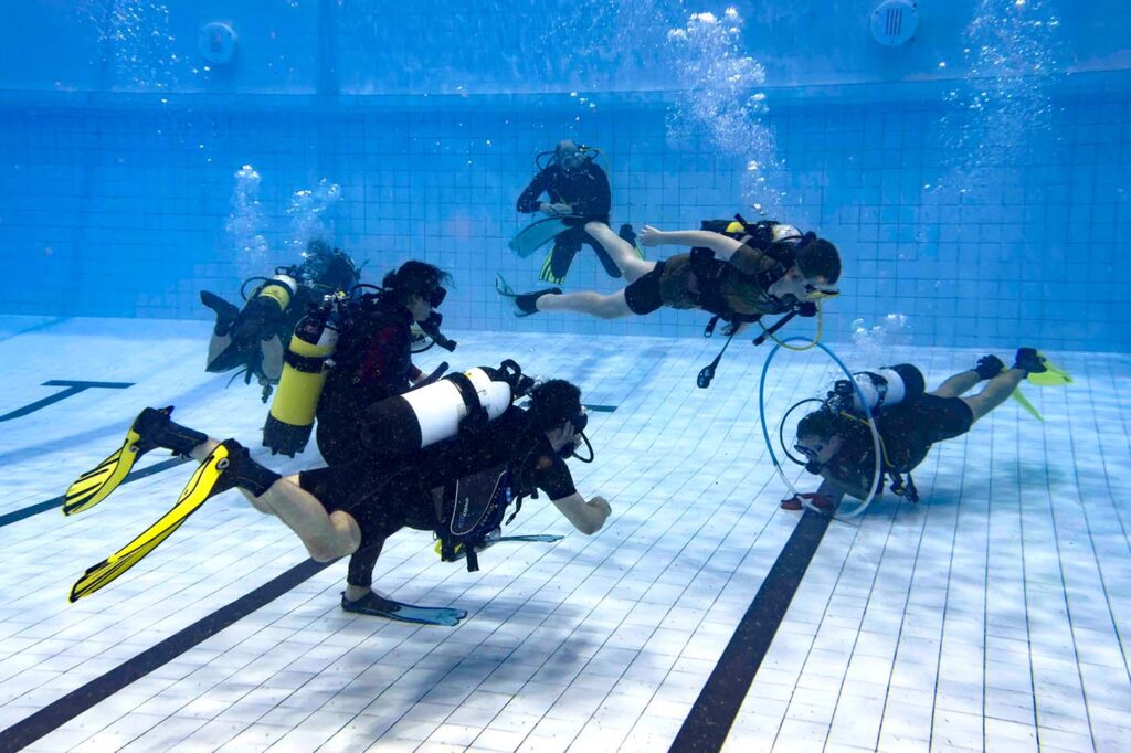 Diver testing fins in confined water or pool